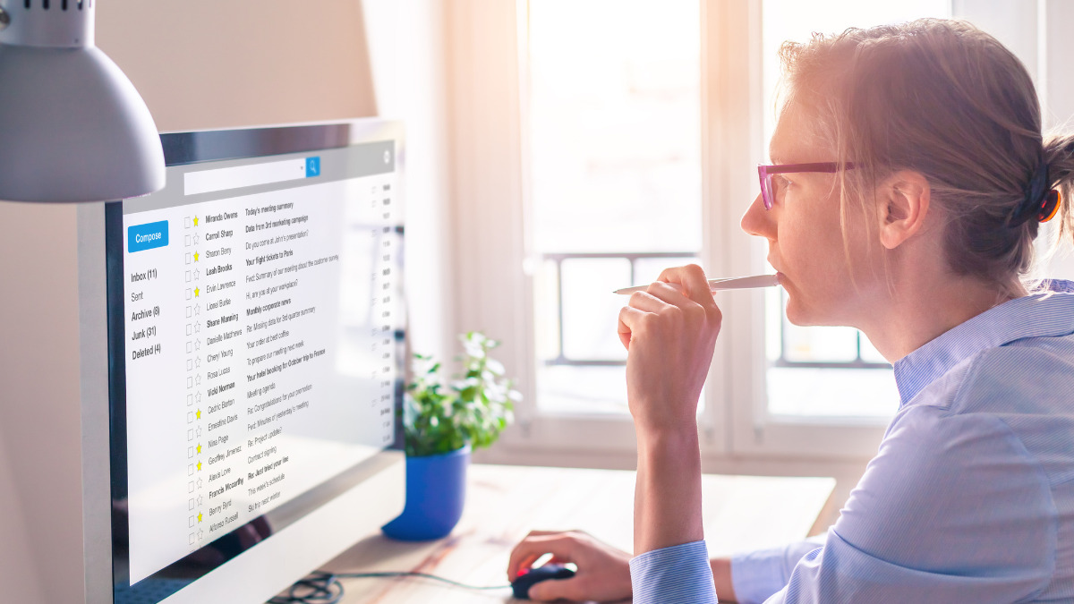 Woman looking at her email inbox on a computer