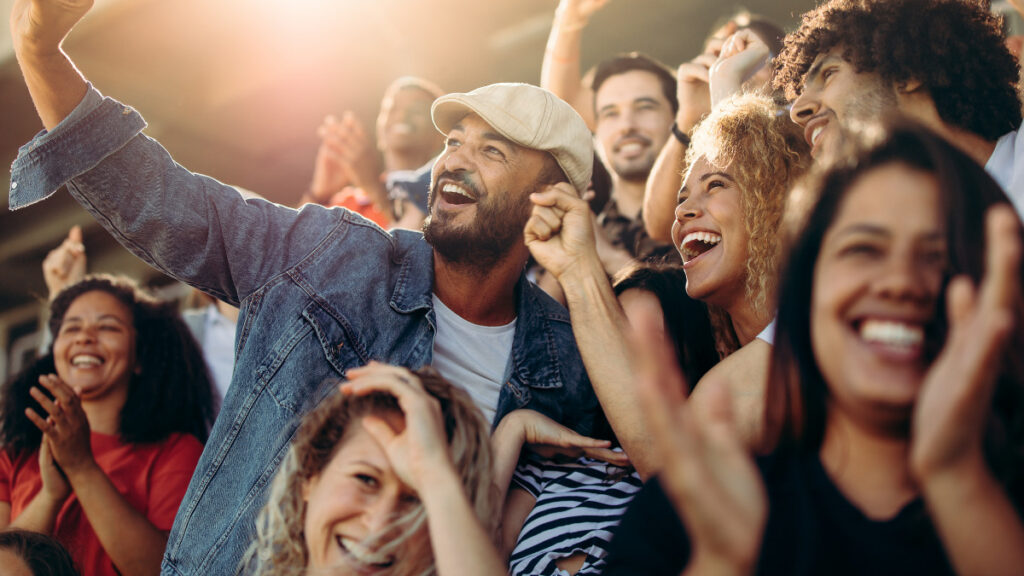 crowd of fans having fun at a sport event